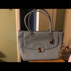 Light blue coach bag with tag attached.